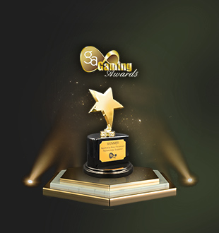 A gold trophy shaped like a star, placed on a pedestal with the word 'WINNER' inscribed on it, illuminated by spotlights displayed above against a green background.